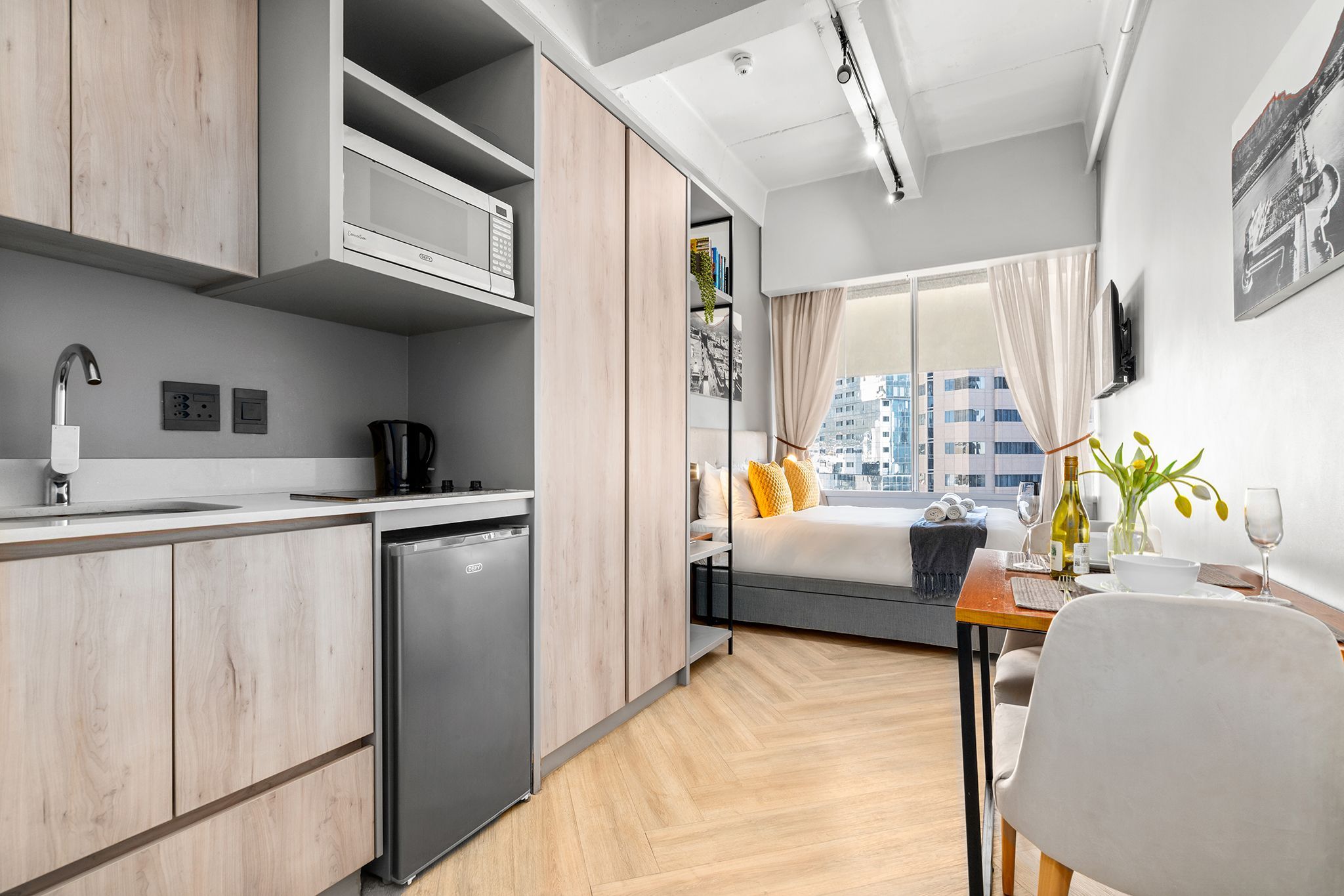 A modern kitchen with a built-in microwave, a coffee machine, and a dishwasher.