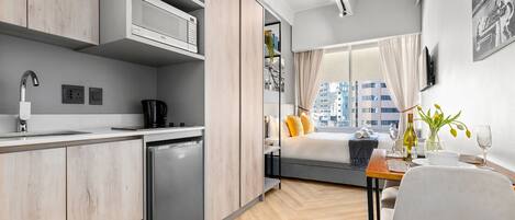 A modern kitchen with a built-in microwave, a coffee machine, and a dishwasher.
