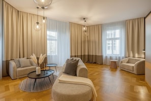 A spacious living room with two sofas, a coffee table, and a side table. - Chic Two-Bedroom Residence in Vinohrady (Praha 2)