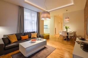 Ein modernes Wohnzimmer mit Sofa, Couchtisch und Essbereich.