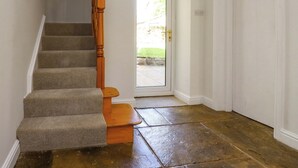 A staircase with carpeted steps and wooden handrails, leading to a door with a glass panel. - 6 Hazel Moor (Blackburn)