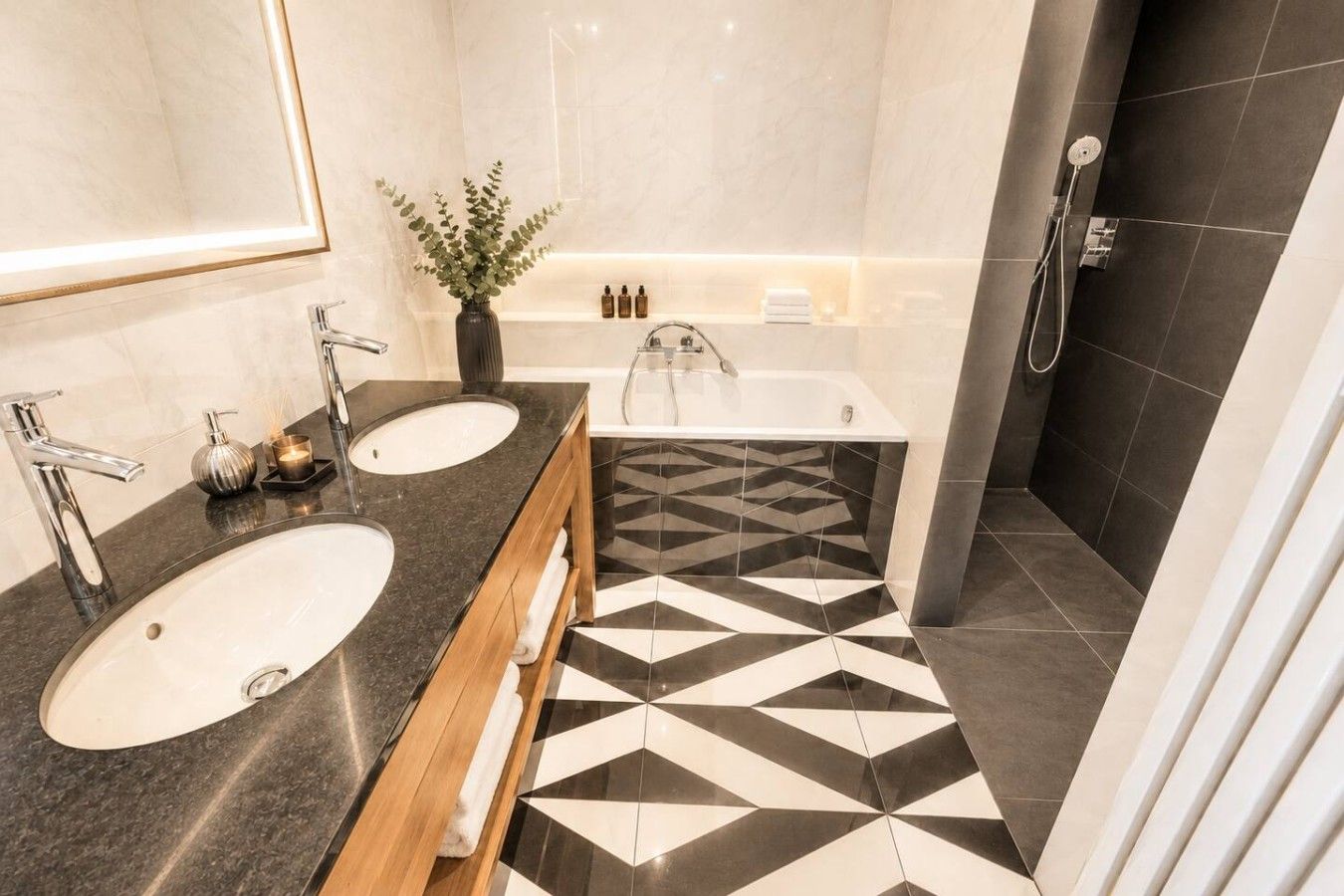 A modern bathroom with two sinks, a bathtub, and a shower.