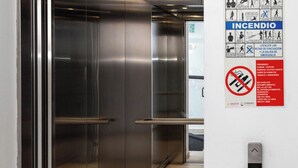 An elevator interior with metallic walls, a control panel, and an emergency exit sign. - Gdl Sky Luxury residence (Zapopan)