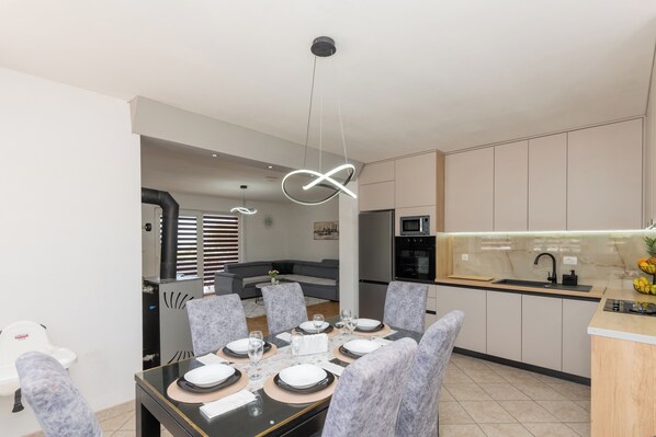A modern kitchen with a built-in oven, microwave, and sink. - Villa Nina With Private Pool and Peacful Oasis (Imotski)