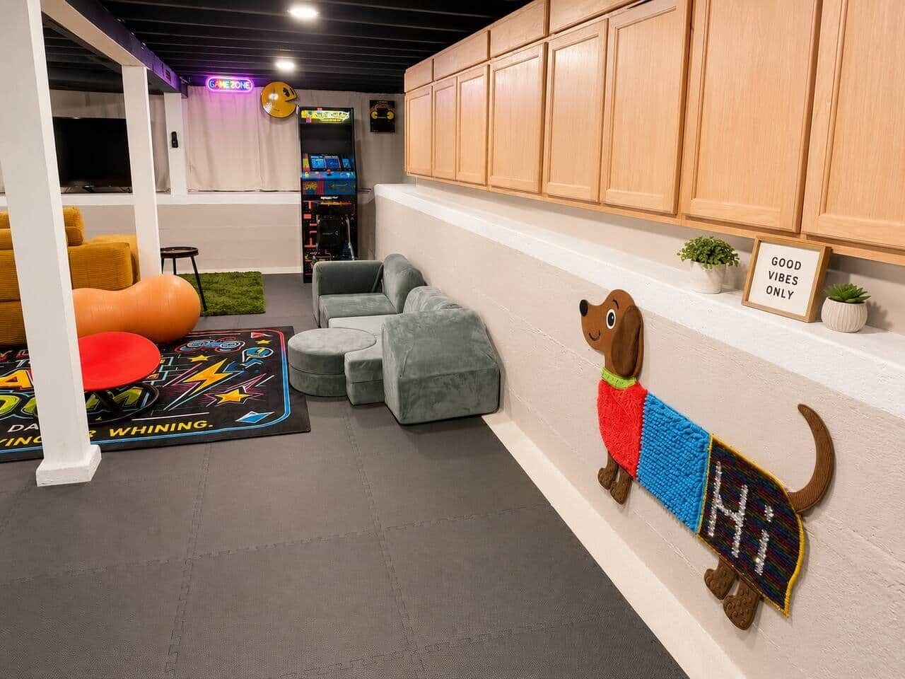 A room with a sofa, ottoman, wall-mounted dog decoration, cabinets, and a neon sign.