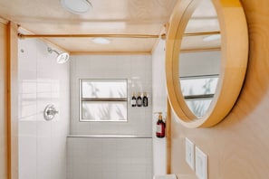 A bathroom with a shower, a window, and a mirror. - The 56 · A Spartan Royal Manor · Dogs Welcome (Sheridan)