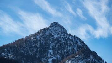 A mountain with a snow-covered peak and a clear sky.