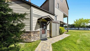 A two-story house with a stone foundation, a garage, and a well-maintained lawn. - Modern Studio Condo with Private Boat Dock (South Lake Tahoe)