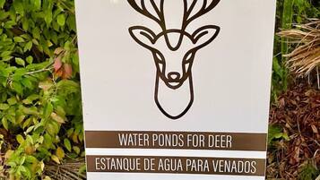 A sign with a deer head and text indicating water ponds for deer.