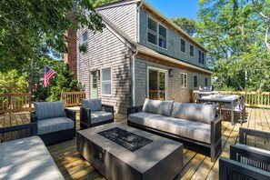 A deck with outdoor furniture, a fire pit, and a dining area. - 1 Mile to Campground Beach, Dog Friendly, AC! (Eastham)