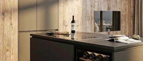 A modern kitchen with a built-in wine cooler, wooden wall paneling, and a large mirror.