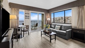 A hotel room with a balcony, a sofa, a coffee table, a TV, and a dining area. - Spacious Tampa Bay Suite w/ Conservation Views (Tampa)