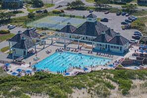 An aerial view of a resort with a large swimming pool, tennis courts, and a parking area. - Return on Relaxation | Walk to Beach + Trails (Nags Head)