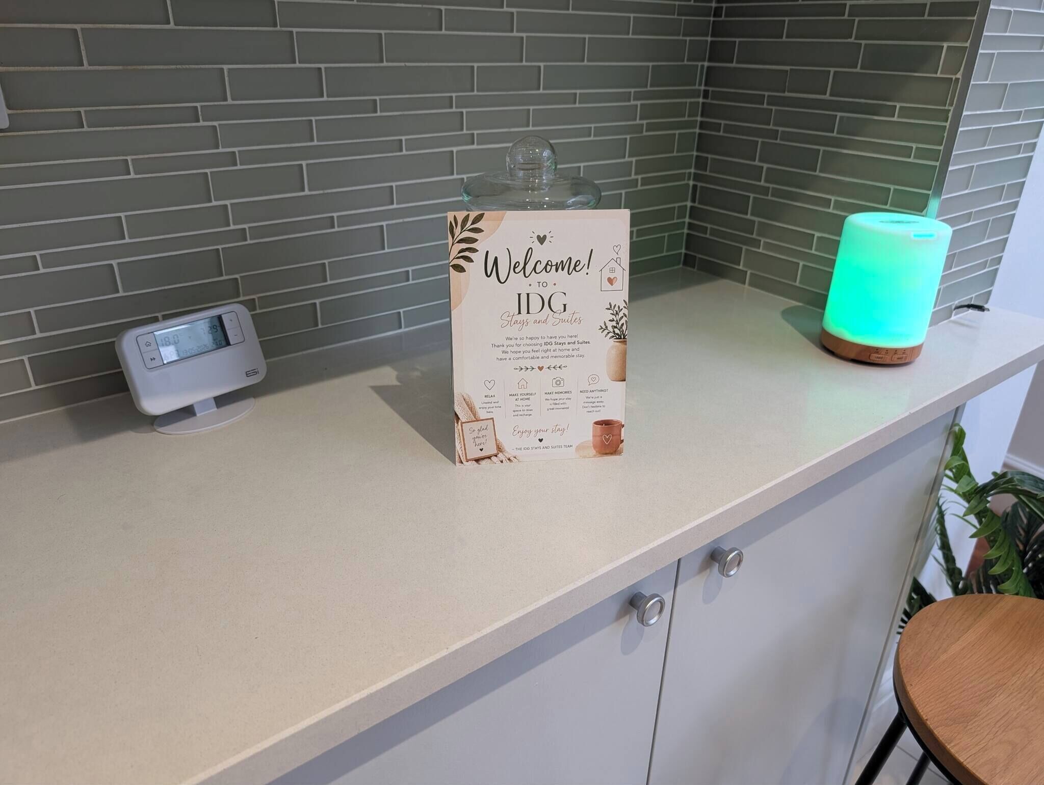 A reception area with a welcome sign, a digital clock, and a green ambient light.