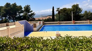 A swimming pool with a view of a cityscape and mountains in the background.