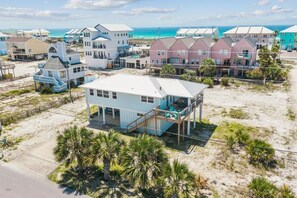 A beachfront property with multiple houses, a covered deck, and a sandy beach. - Unobstructed views of the Santa Rosa Sound! Sleeps 12. (Navarre)