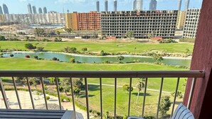 A balcony with a view of a golf course and buildings. - lagoons and golf Arya view (Marsa Matrouh Governorate)