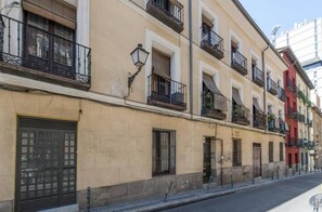 A row of multi-story buildings with balconies, windows, and doors. - Gran Vía VI (Madrid)