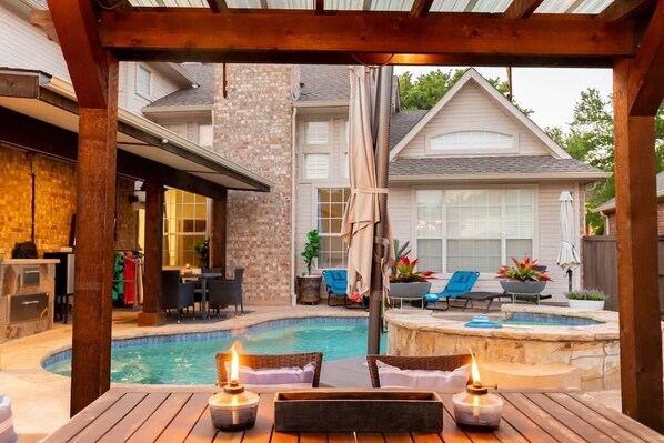 A backyard with a swimming pool, outdoor seating, and a pergola. - Stay at Golden Hour | Pool + Hot Tub | Sleeps 10+ (Irving)