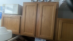 Wooden cabinets, a microwave, and a sink.