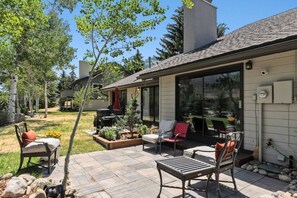A patio with outdoor furniture, a barbecue grill, and a covered seating area. - Eagle Vail Retreat On Golf Course | Fire Pit (Avon)