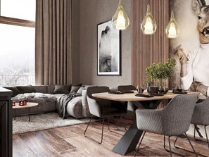 A modern living room with a sofa, dining table, chairs, and a fireplace. - Holiday Apartment With Sauna Access (Ladis)
