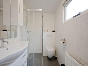 A modern bathroom with a glass-enclosed shower, a white sink, and a toilet. - Chalet 56 in Stegeren Near the Heathlands (Stegeren)
