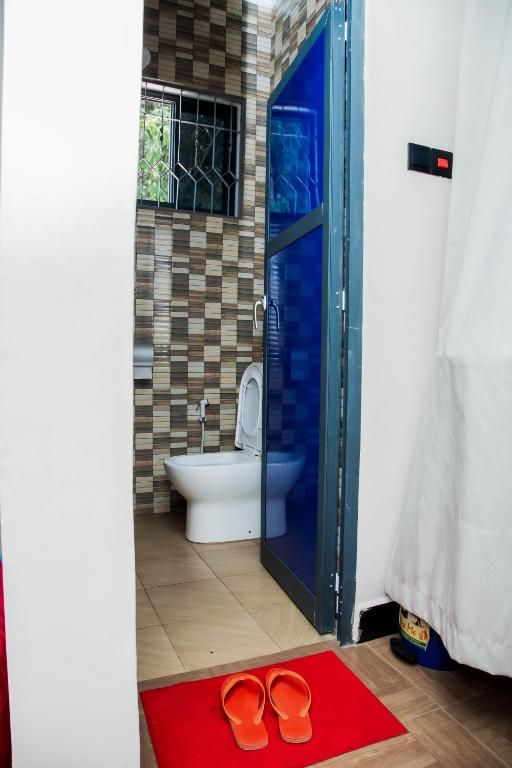 A bathroom with a toilet, a bidet, and a shower area.