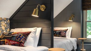 A bedroom with two beds, each with a unique pillow design, a sloped ceiling, and a window with a view. - Cedar Hall - A Charming Vintage Estate (Lebanon)