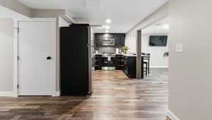 A modern kitchen with a refrigerator, microwave, and stove. - Modern Reynoldsburg Retreat Near Columbus (Reynoldsburg)