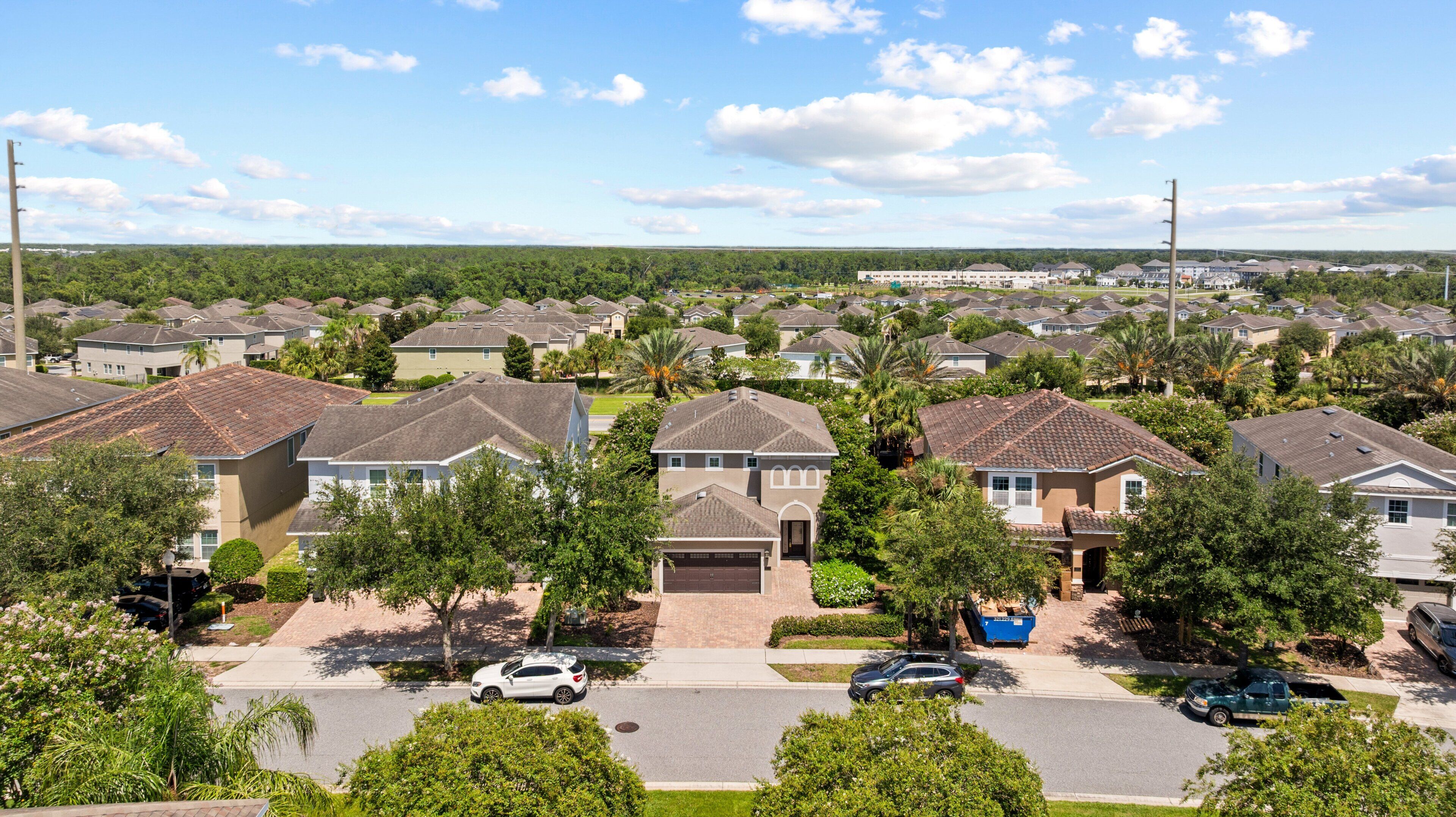 A residential area with houses, streets, and a clear sky.