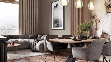 Una sala de estar moderna con un sofá, una mesa de comedor, sillas y una chimenea.