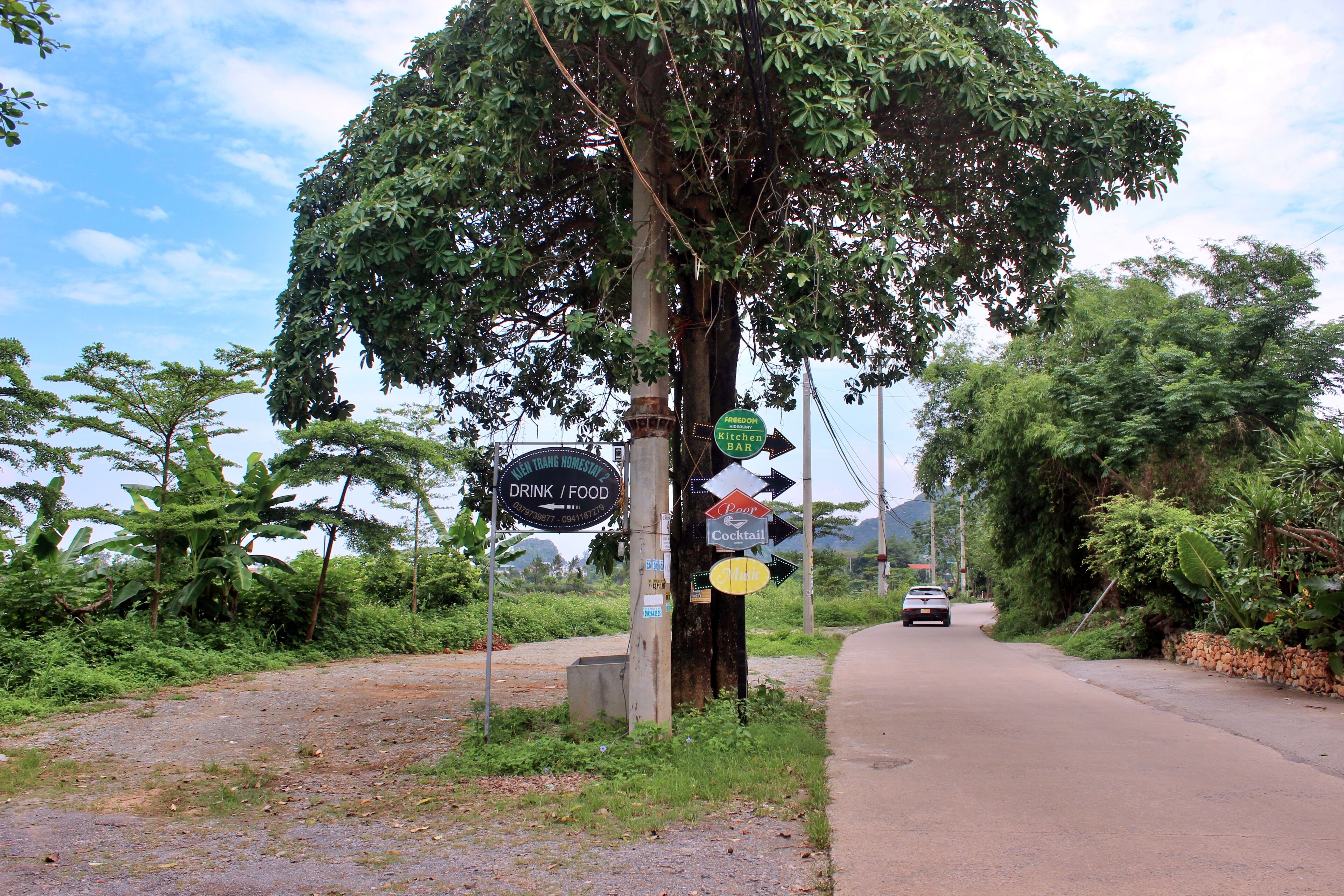 A roadside sign with directions to a restaurant and a hotel.
