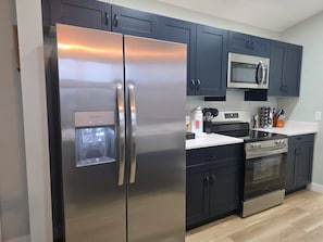 Coffee/tea maker, fridge, microwave, oven