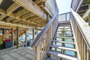 A wooden deck with a staircase leading to a dock over water. - Durango 121 pet friendly, private dock (Destin)