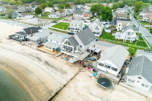 A coastal residential area with houses, a beach, and a swimming pool.