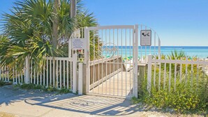 A gated entrance to a beach area with a clear view of the ocean. - Private Beach Access, Sleeps 6, Pool & More! (Miramar Beach)