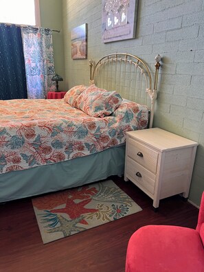 A bedroom with a bed, nightstand, dresser, and a rug. - Large home located in the countryside with swimming pool and backyard pool room. (Woodland)