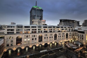 A hotel with multiple floors, arched windows, and a rooftop terrace. - The Raphael Penthouse Suites (Johannesburg)
