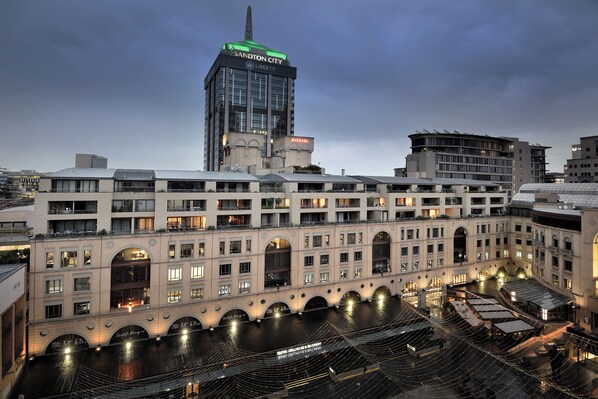 A hotel with multiple floors, arched windows, and a rooftop terrace. - The Raphael Penthouse Suites (Johannesburg)