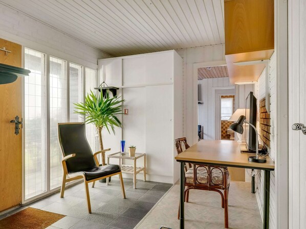 A modern interior with a dining area, a potted plant, and a television. - 4 Star Holiday Home in Hjorring (Hjørring)