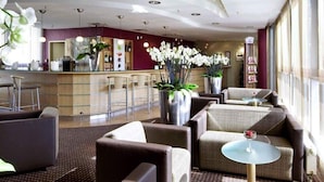 A hotel lobby with seating, a reception desk, and large windows. - 2 Person Holiday Park Home in Dortmund (Dortmund)