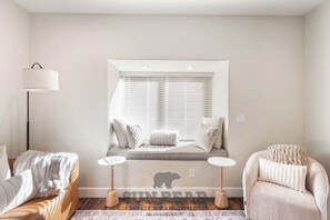 A room with a built-in window seat, a lamp, a sofa, and a chair. - StayIncline at Village at Incline (VAI49) (Incline Village)