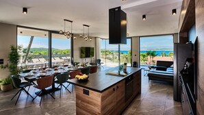 A modern kitchen with a central island, large windows, and a view of the sea. - Beautiful home in Zdrelac with sauna (Zdrelac)