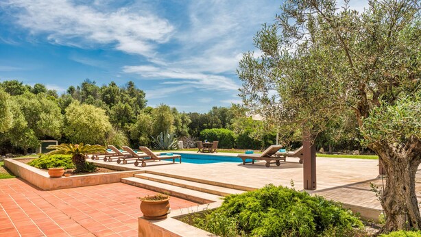 A pool area with lounge chairs, a swimming pool, and surrounding greenery. - Villa Mig Coster - A rural retreat on a private estate (Sant Lluís)
