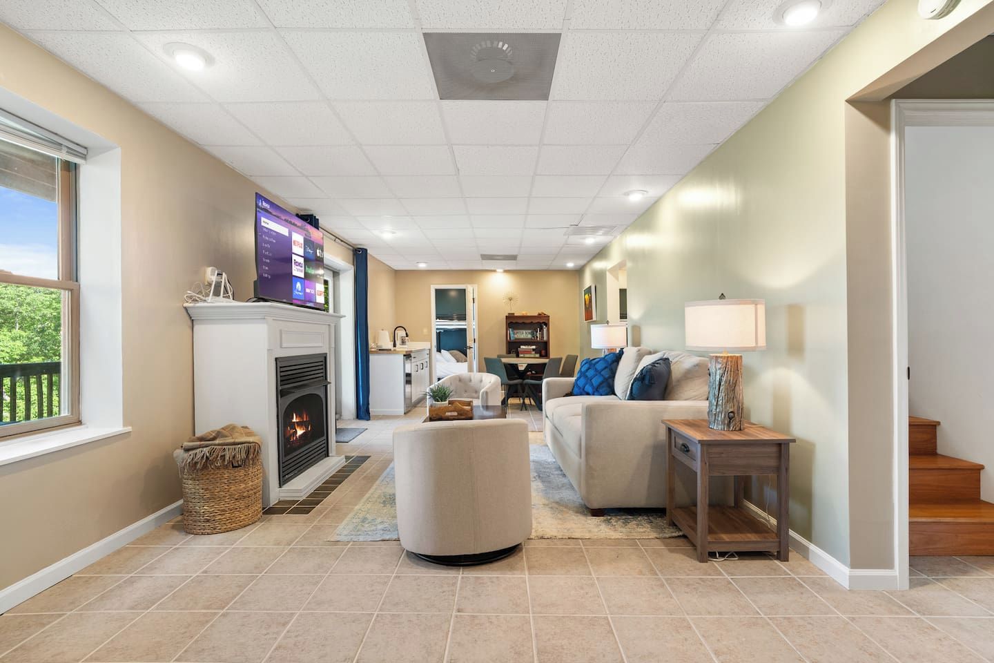 A living room with a fireplace, a television, and a dining area.