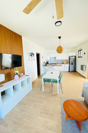 A modern kitchen with white cabinets, a built-in oven, and a refrigerator. - Perfect Place in Samana 1 (Samaná)