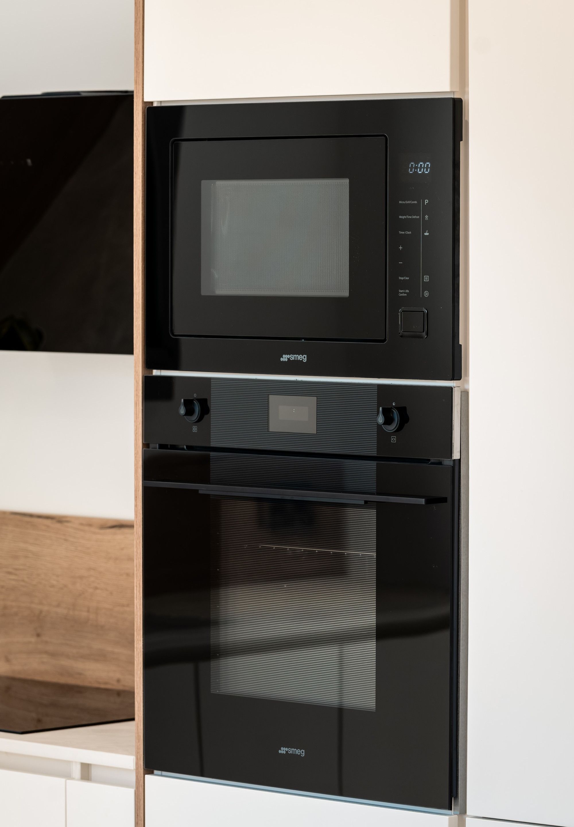 A black microwave and oven unit with a digital display and control panel.