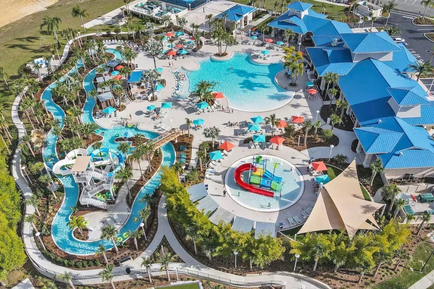 A resort with multiple swimming pools, water slides, and sun loungers.