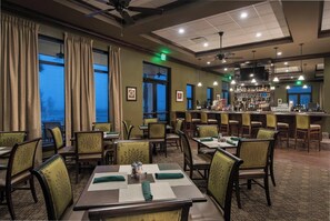 A restaurant with tables and chairs, a bar area, and large windows with curtains. - SARASOTA NATIONAL - SEASONAL RENTAL -WITH GOLF MEMBERSHIP FOR 2 - 3 BR/2 BATH (Venice)